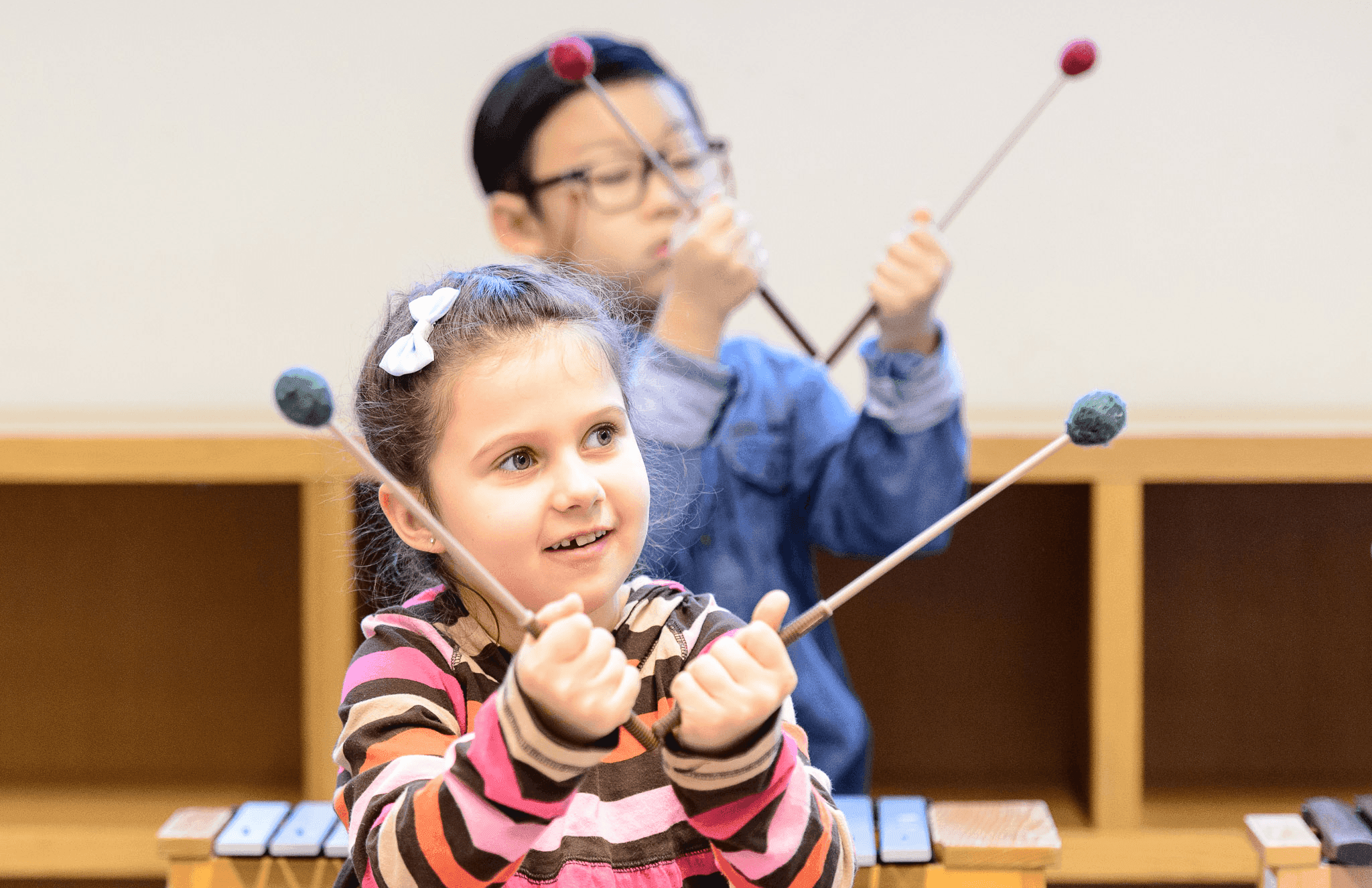 kids holding xylophone sticks
