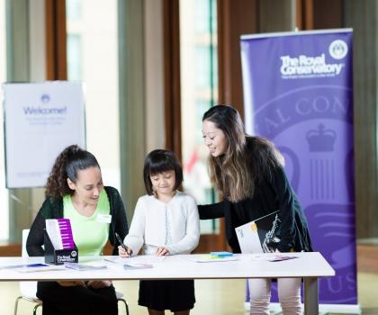 staff assisting lady and child