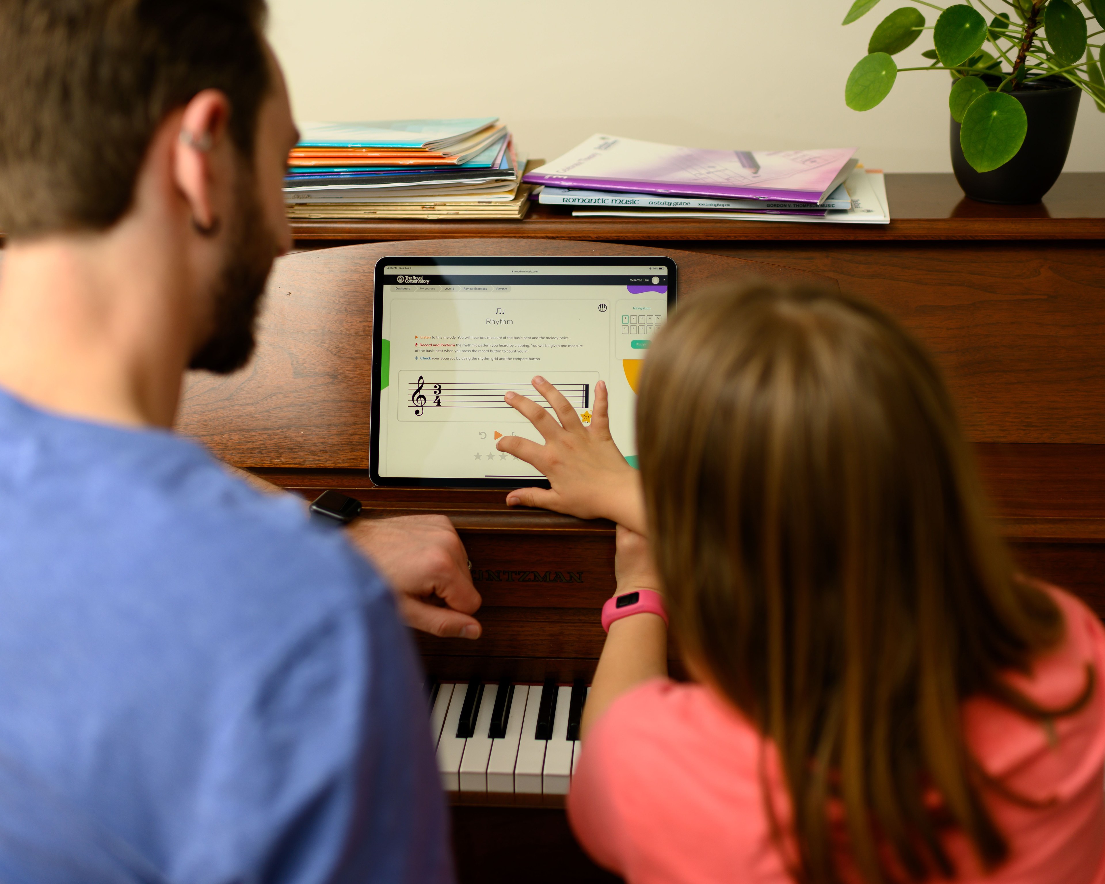 man teaching child piano